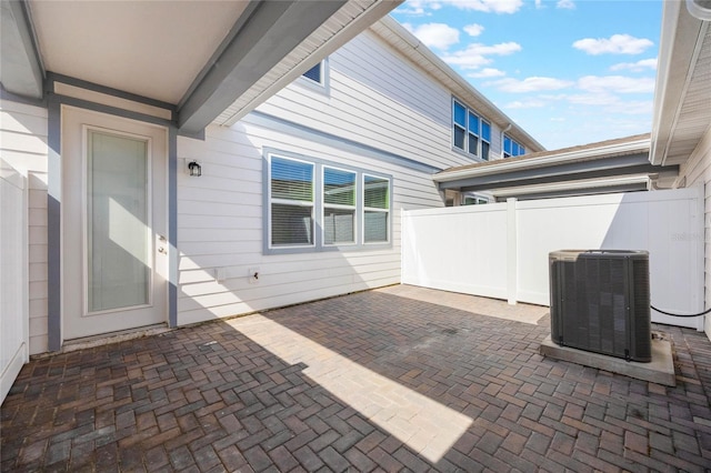 view of patio featuring central air condition unit and fence