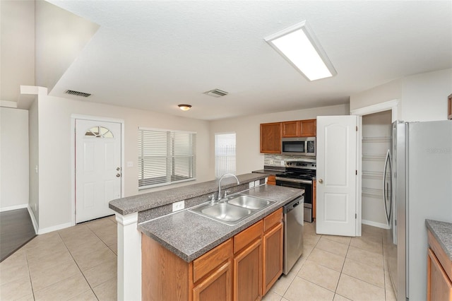 kitchen featuring light tile patterned flooring, visible vents, stainless steel appliances, and a sink