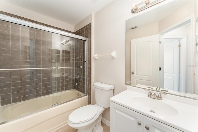 bathroom featuring combined bath / shower with glass door, visible vents, toilet, and vanity