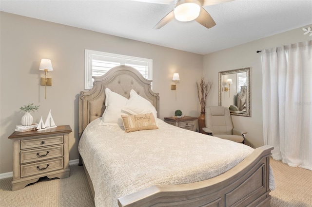 bedroom featuring a ceiling fan, light colored carpet, and baseboards