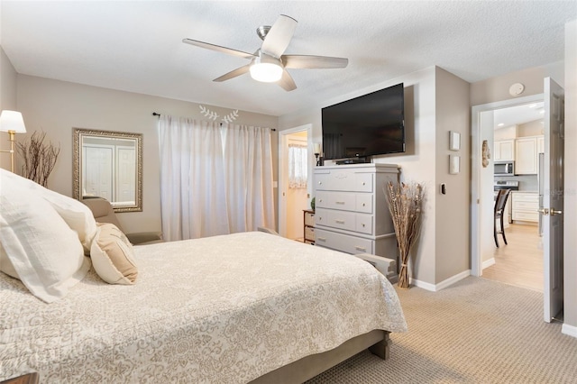 bedroom with baseboards, light carpet, a textured ceiling, and ceiling fan