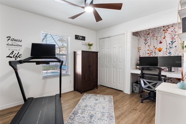 office area with baseboards, ceiling fan, and light wood finished floors