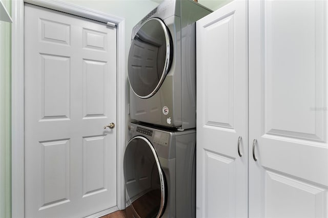 laundry room featuring cabinet space and stacked washer / drying machine