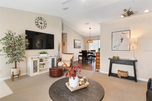 living area featuring vaulted ceiling, baseboards, and visible vents