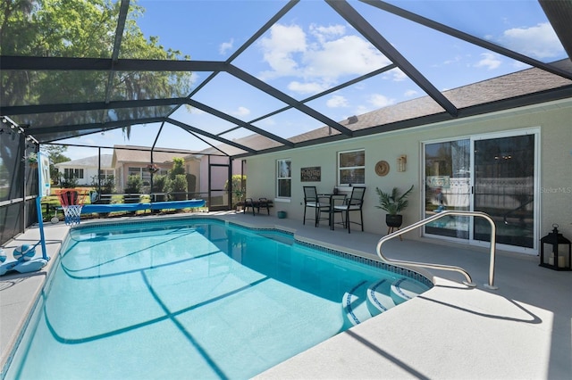 outdoor pool featuring a patio area and glass enclosure