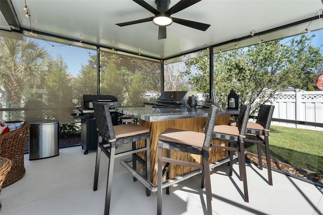 sunroom with a ceiling fan