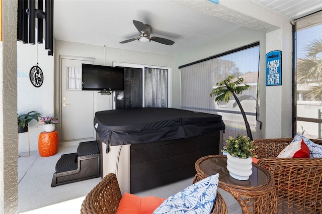 view of patio / terrace with a ceiling fan and a hot tub