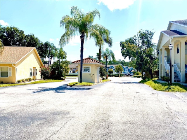 view of road with a residential view and street lighting