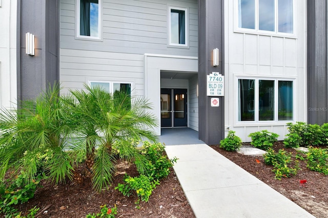 property entrance with french doors and board and batten siding