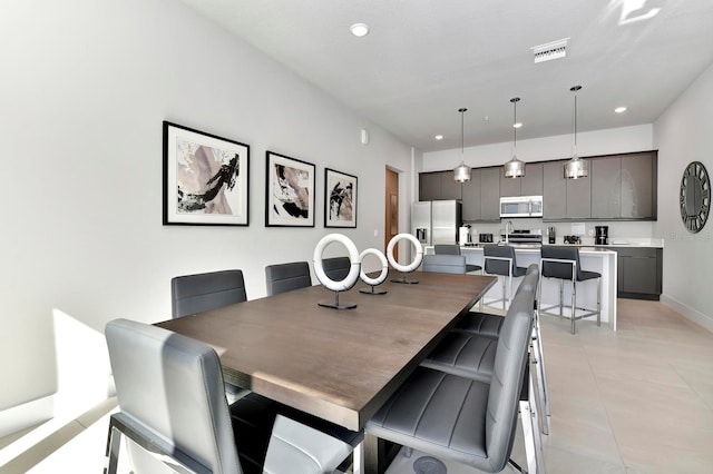 dining area with light tile patterned floors, visible vents, recessed lighting, and baseboards