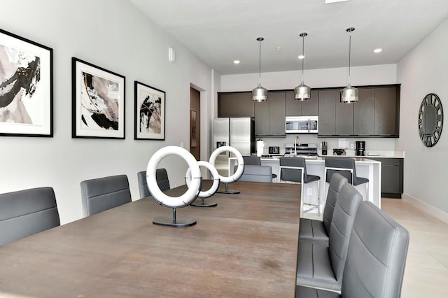 dining space with recessed lighting and baseboards