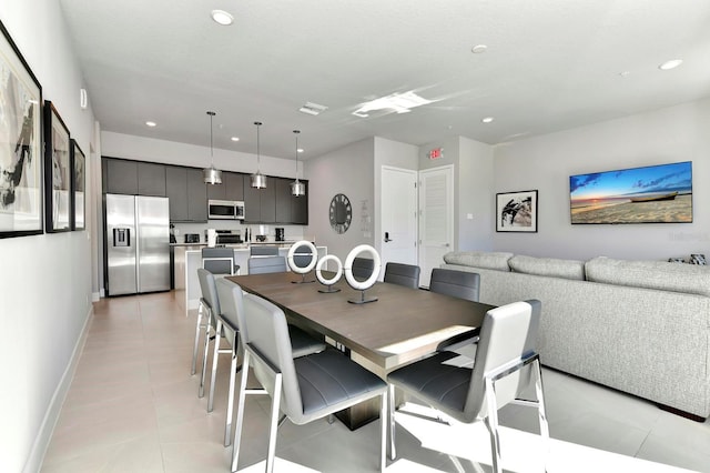 dining space with light tile patterned floors, recessed lighting, visible vents, and baseboards