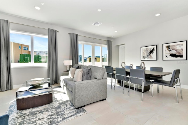 living room with recessed lighting, visible vents, and a healthy amount of sunlight