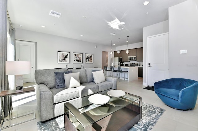 living area featuring recessed lighting, visible vents, and light tile patterned floors