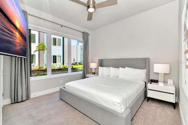 carpeted bedroom featuring a ceiling fan and baseboards