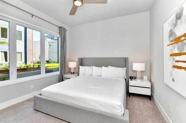 carpeted bedroom featuring a ceiling fan and baseboards