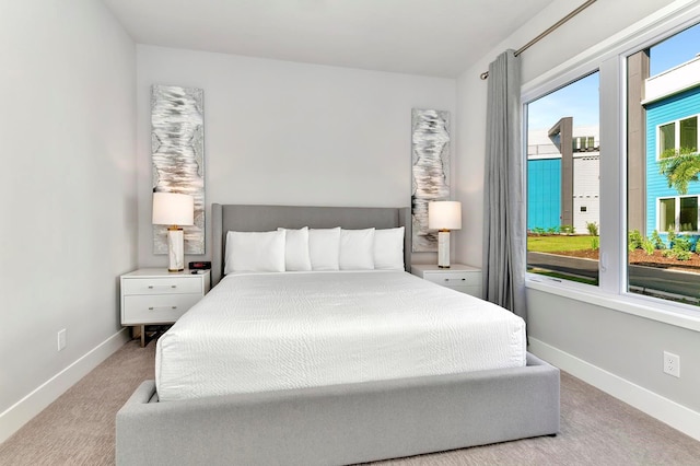 carpeted bedroom featuring baseboards