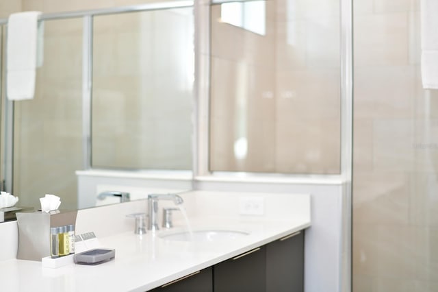 bathroom with a stall shower and vanity