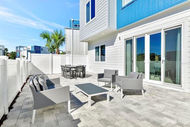 view of patio / terrace with an outdoor living space, a fenced backyard, and outdoor dining space