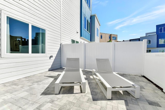 view of patio featuring fence