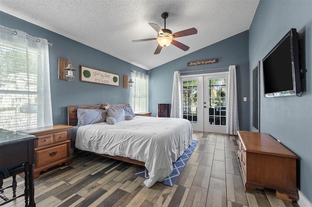 bedroom featuring access to outside, a textured ceiling, wood finished floors, french doors, and vaulted ceiling