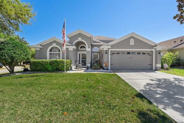 view of front facade featuring concrete driveway, a garage, a front yard, and stucco siding