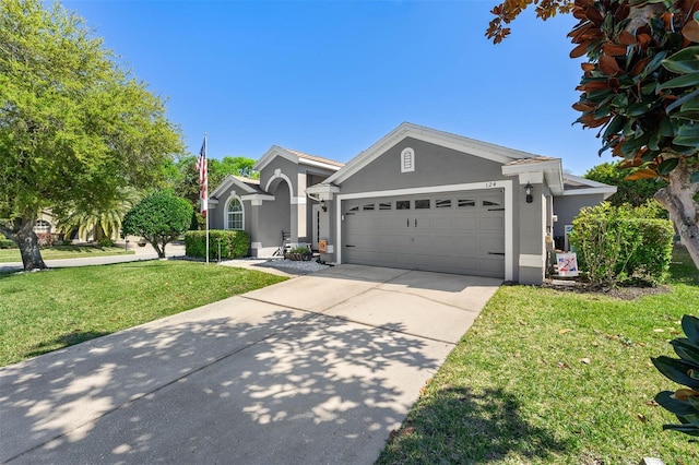 view of front of house featuring stucco siding, driveway, a front lawn, and a garage