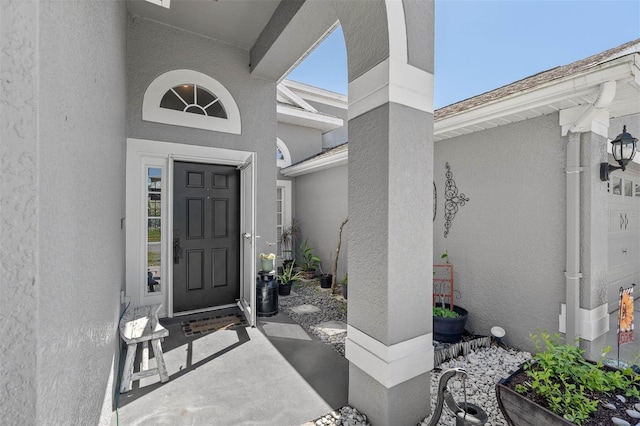 doorway to property with stucco siding