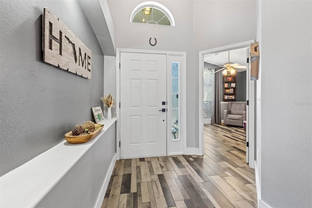 entrance foyer featuring baseboards and wood finished floors