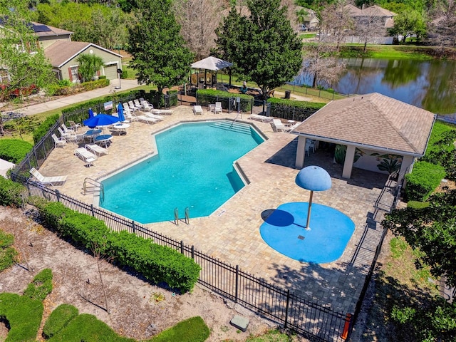 pool featuring a gazebo, a water view, fence, and a patio area