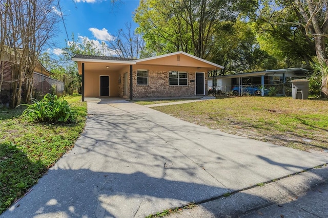 2108 W 15th, Jacksonville, FL 32209 - view of front of property featuring driveway, a carport, brick siding, and a front yard