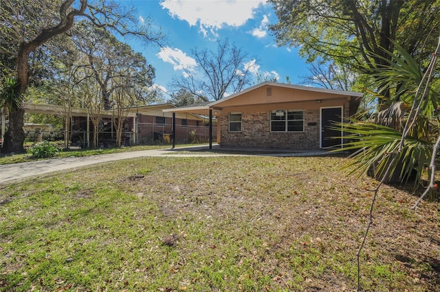 2108 W 15th, Jacksonville, FL 32209 - back of house featuring brick siding, fence, concrete driveway, a yard, and a carport