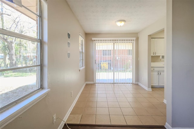 2108 W 15th, Jacksonville, FL 32209 - interior space featuring light tile patterned flooring, a textured ceiling, and baseboards