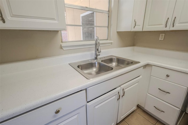 2108 W 15th, Jacksonville, FL 32209 - kitchen with light tile patterned floors, white cabinets, light countertops, and a sink
