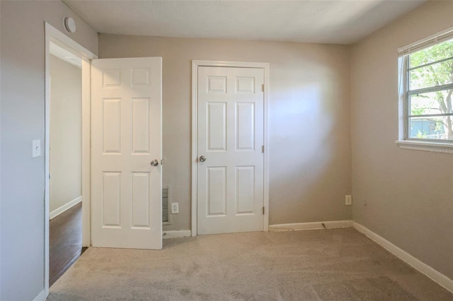 2108 W 15th, Jacksonville, FL 32209 - unfurnished bedroom featuring baseboards and carpet
