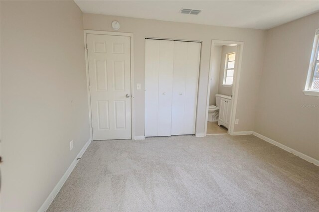 2108 W 15th, Jacksonville, FL 32209 - unfurnished bedroom featuring carpet, visible vents, baseboards, ensuite bath, and a closet