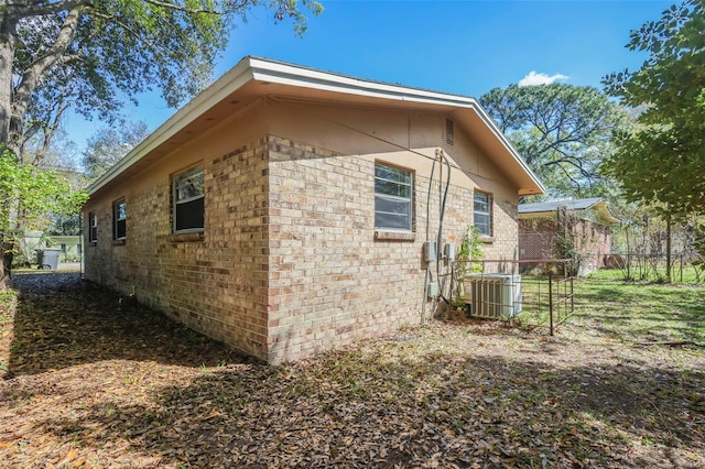 2108 W 15th, Jacksonville, FL 32209 - view of side of property featuring brick siding, central AC unit, and fence