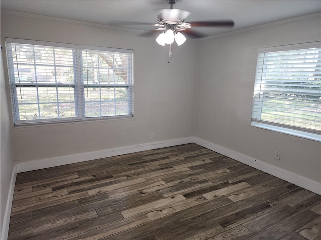 empty room with a wealth of natural light, a ceiling fan, ornamental molding, and dark wood finished floors