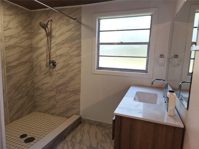 bathroom with marble finish floor, a stall shower, vanity, and baseboards