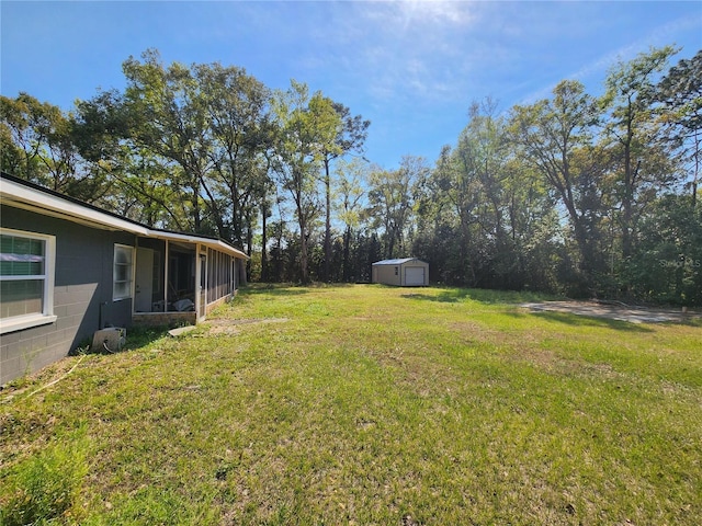 view of yard featuring an outdoor structure, a shed, and a sunroom