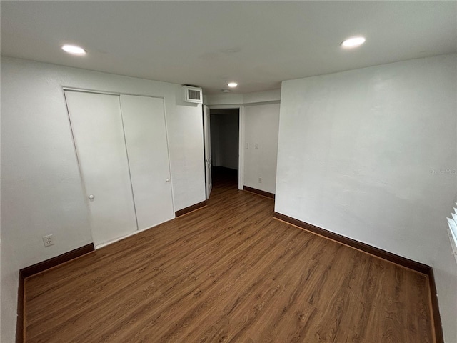 unfurnished bedroom with recessed lighting, visible vents, baseboards, and wood finished floors