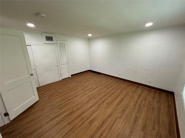 interior space featuring recessed lighting, wood finished floors, visible vents, and baseboards