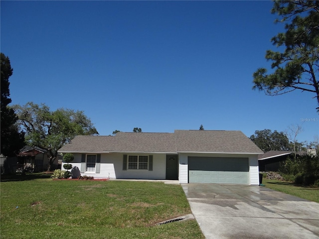 view of front facade featuring a front lawn, concrete driveway, and an attached garage