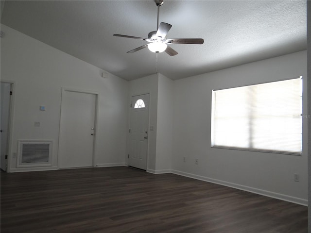 entryway featuring dark wood-style floors, visible vents, a healthy amount of sunlight, and vaulted ceiling