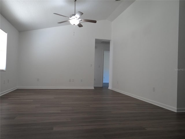 unfurnished room featuring baseboards, a ceiling fan, dark wood-type flooring, and lofted ceiling