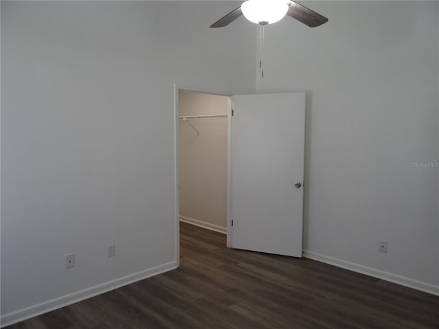 spare room with a ceiling fan, wood finished floors, and baseboards