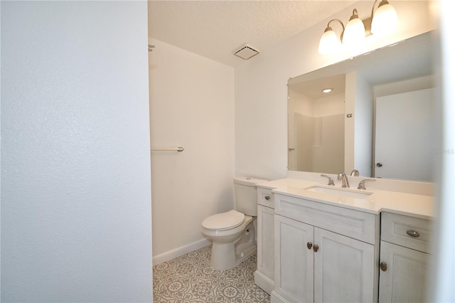 bathroom with visible vents, toilet, tile patterned flooring, baseboards, and vanity