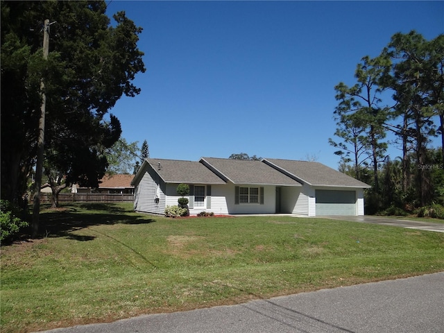 ranch-style house featuring driveway, an attached garage, a front yard, and fence