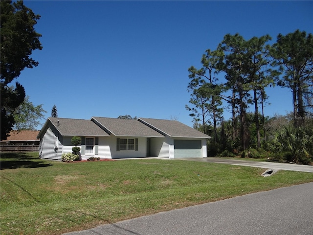 view of front of home featuring driveway, a front lawn, and a garage