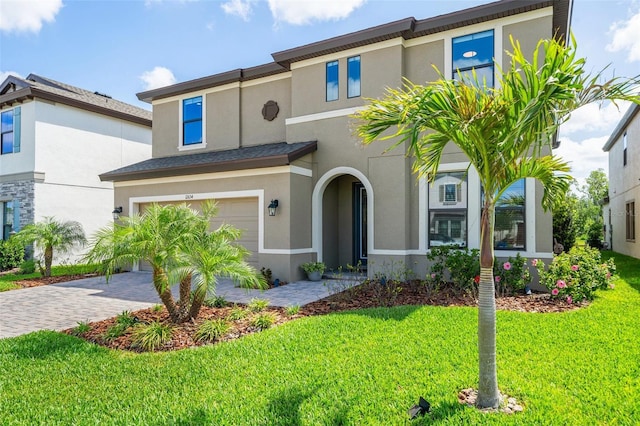 12654 Oak Hill Way, Parrish, FL 34219 - view of front of house featuring stucco siding, a garage, driveway, and a front lawn